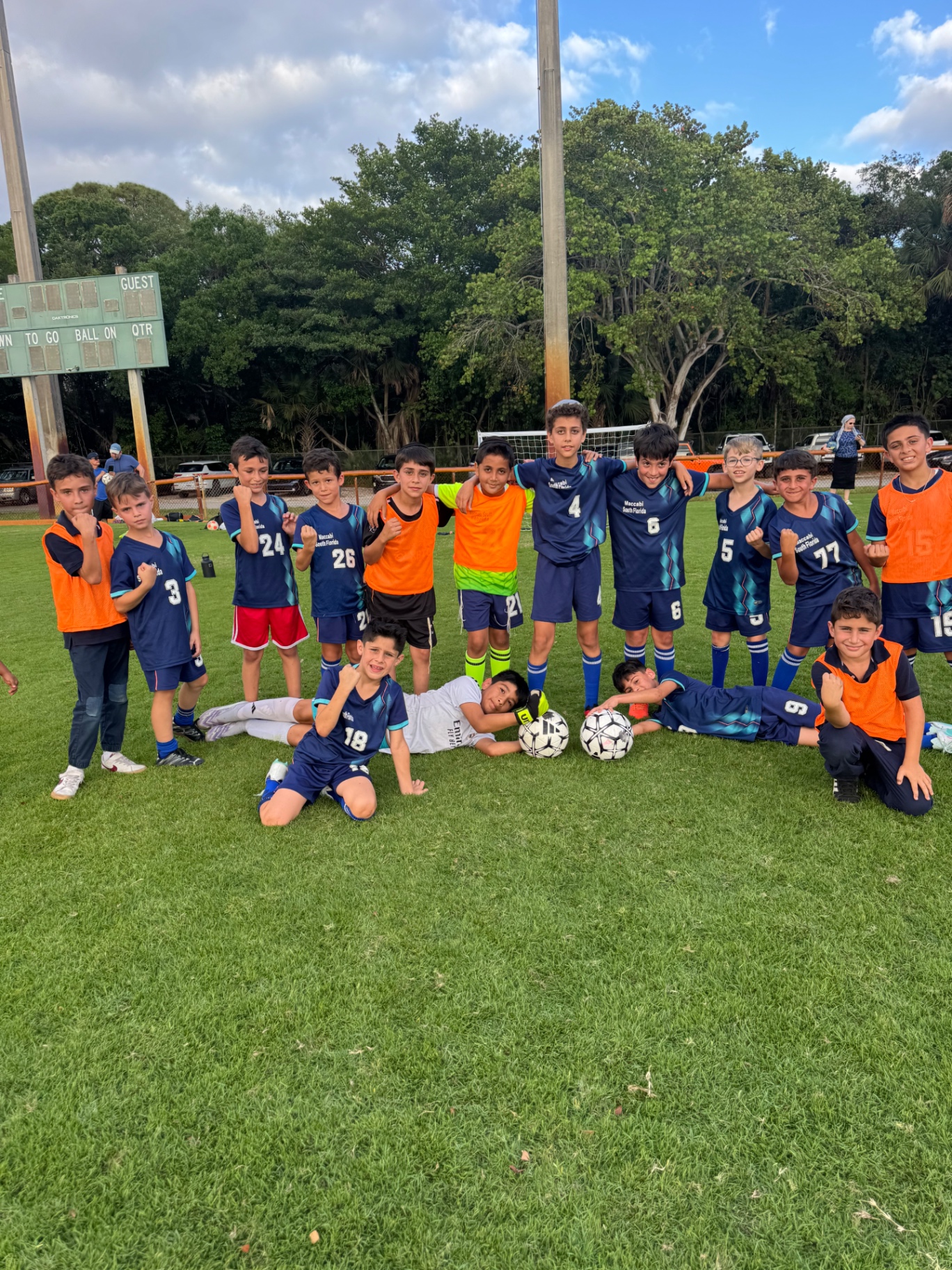 Soccer club for kids South Florida — friendly coach laughing with team