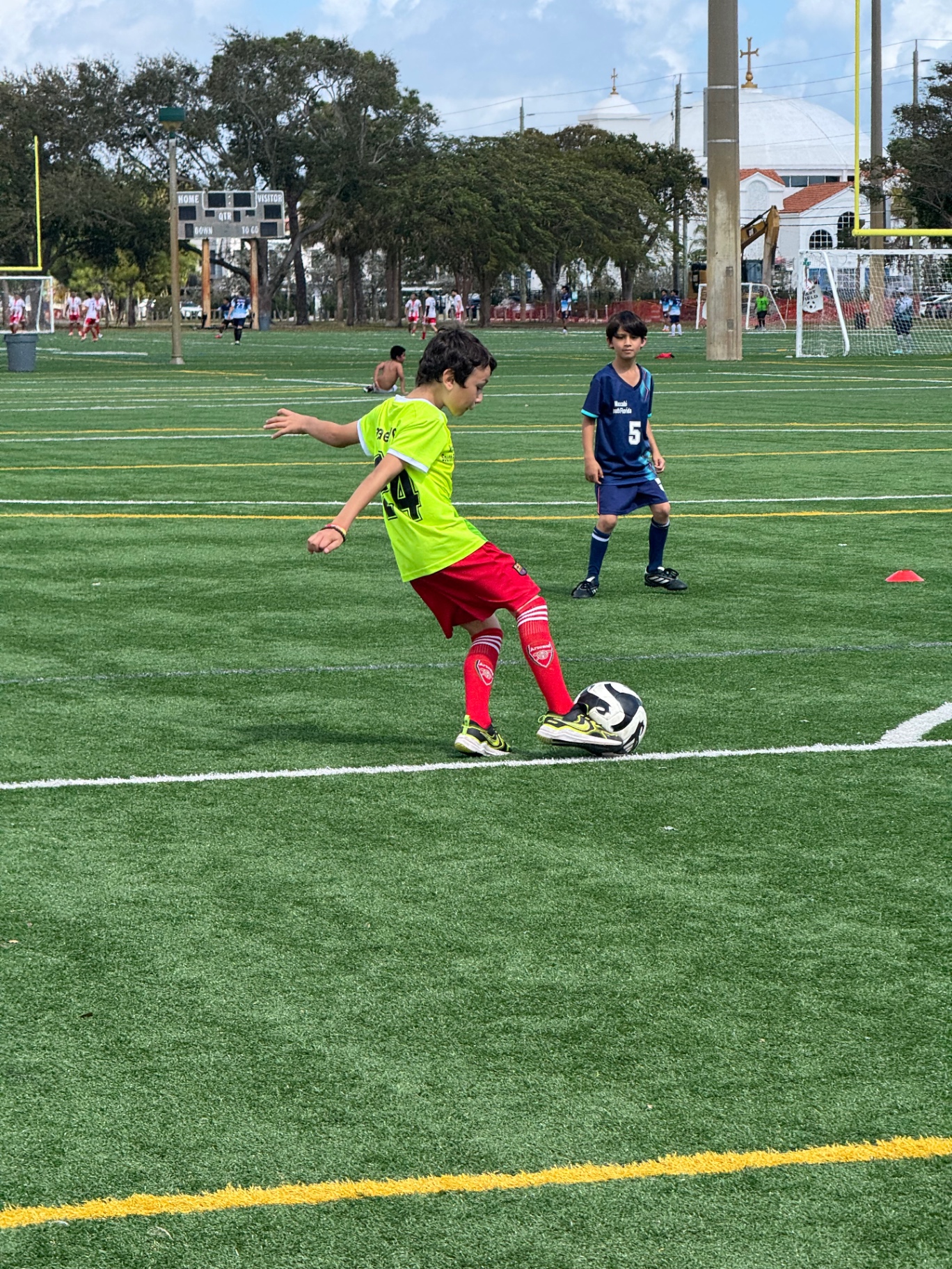 Young Maccabi player taking a shot — kids soccer game Hollywood Florida